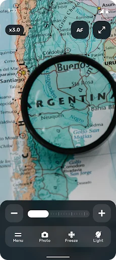 Geographic map magnification at 5.0x zoom focusing on Argentina and Buenos Aires region with magnifying glass tool